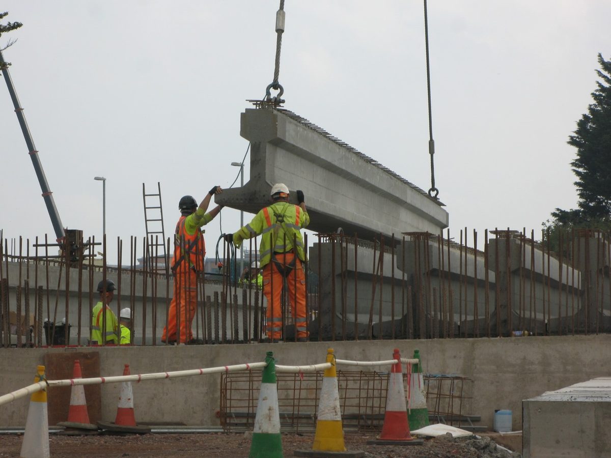 Crane crew installing a bridge beam