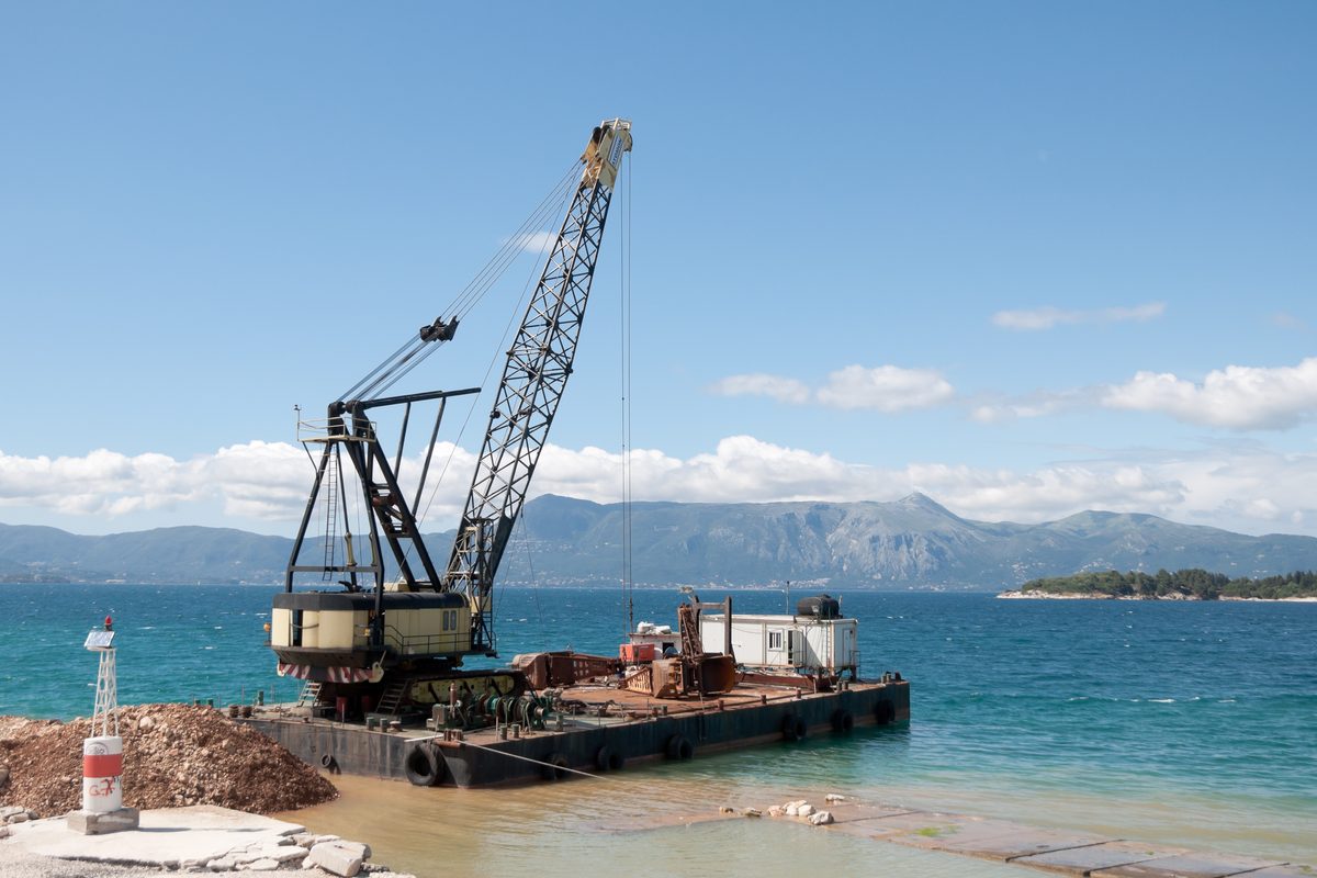 Crane working on a coastal industrial site