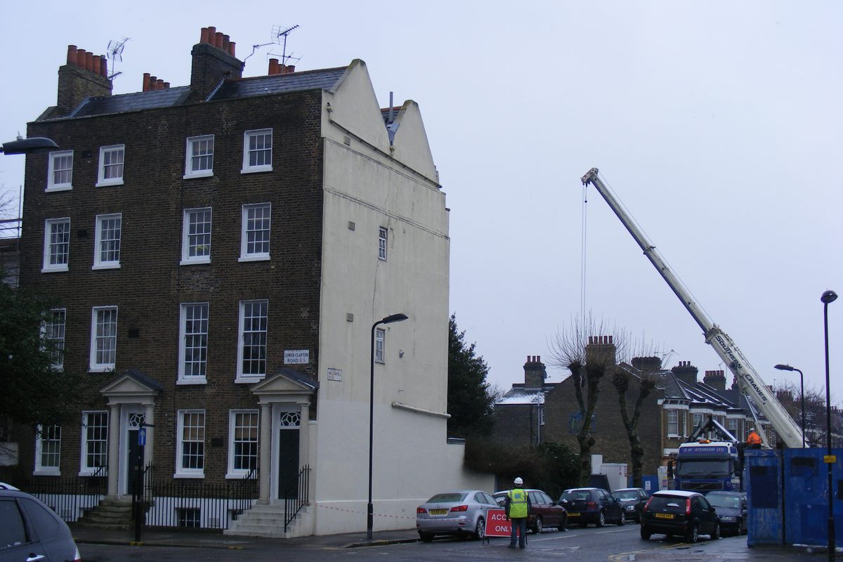 Mobile crane lifting over a residential street